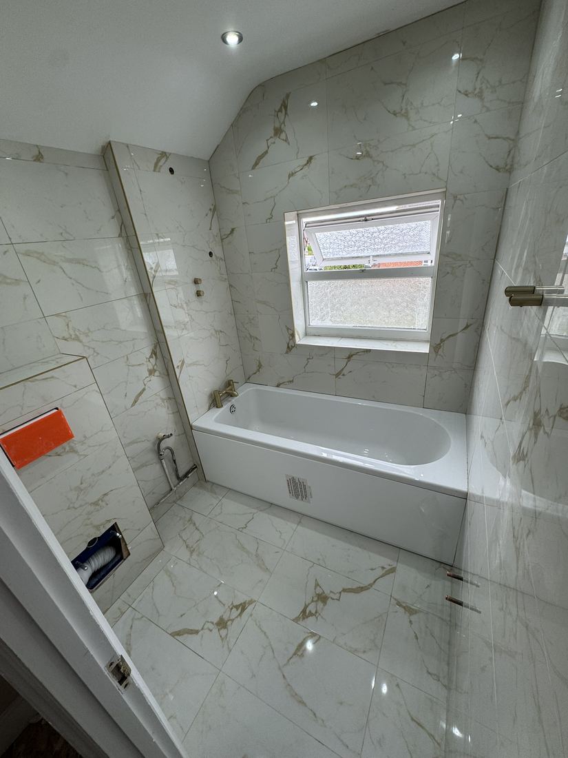Bathroom after: marble-effect tiles and new bath