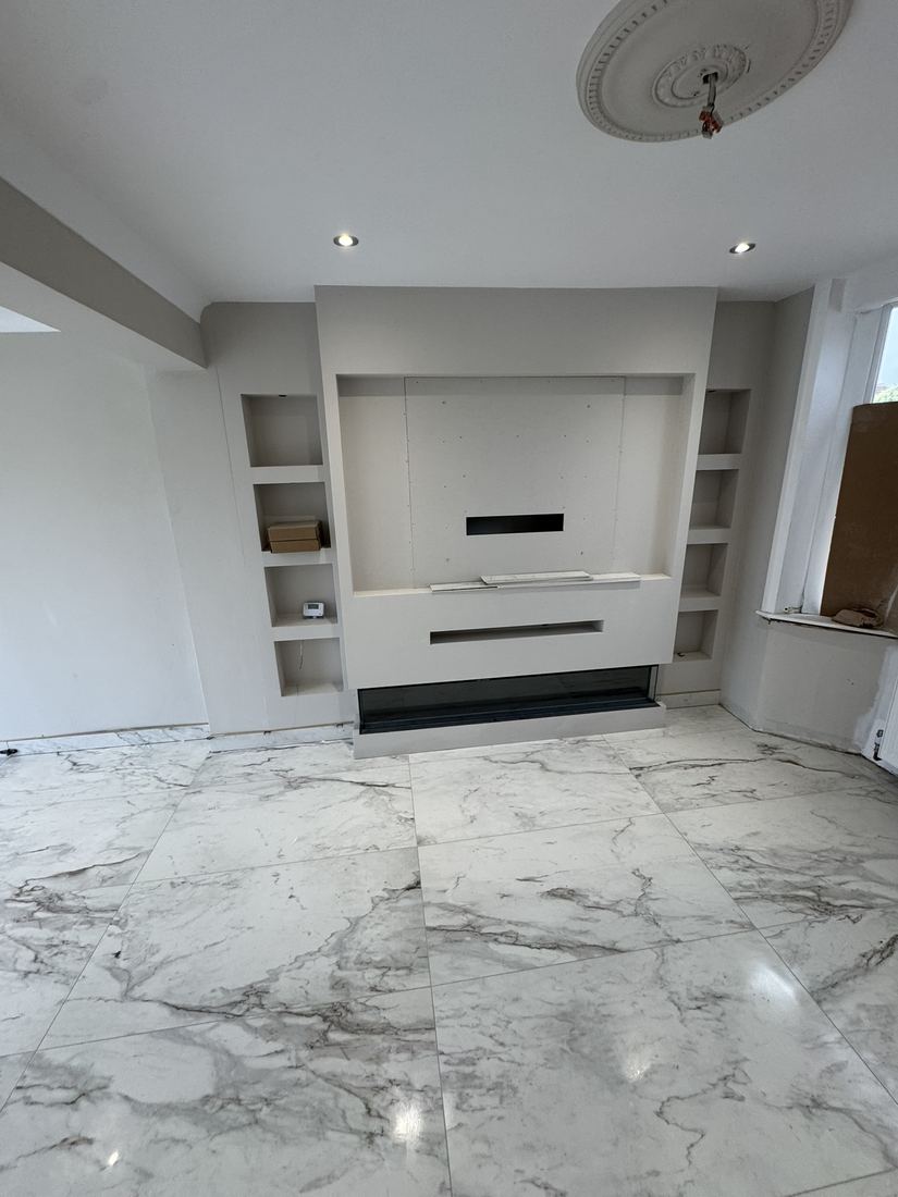 Living room after: media wall and marble-effect floor
