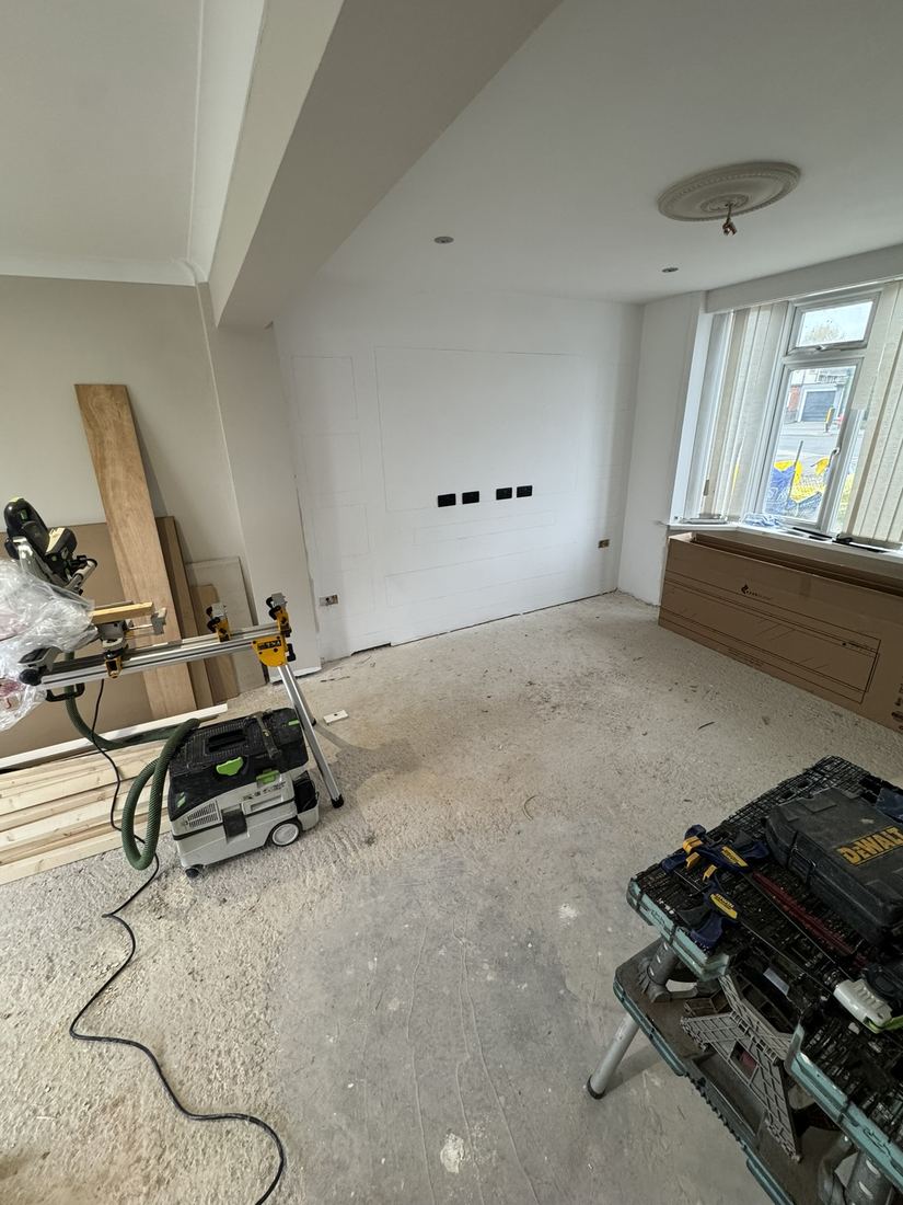Living room before: bare walls and concrete floor