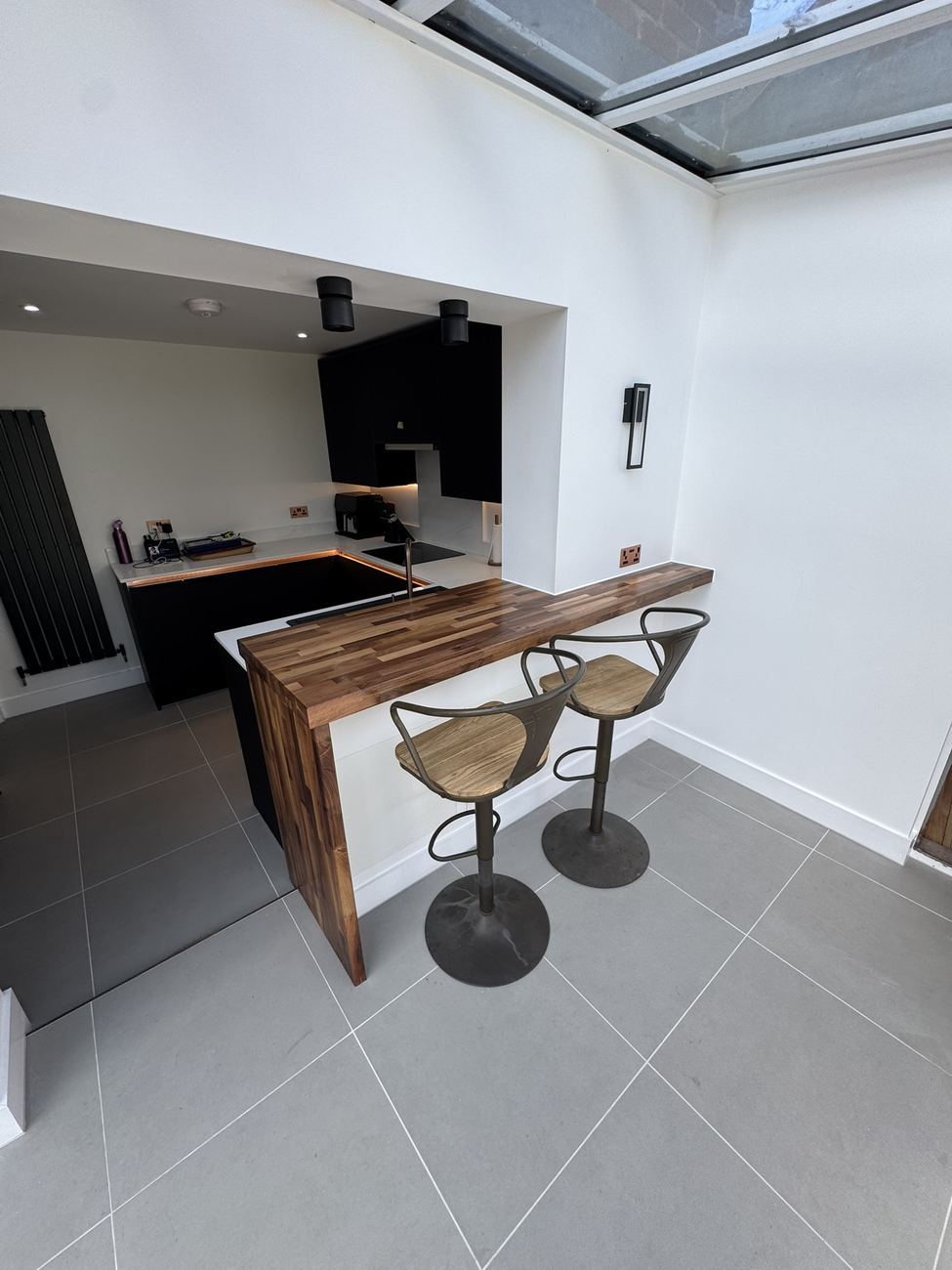 Kitchen with walnut breakfast bar and bar stools