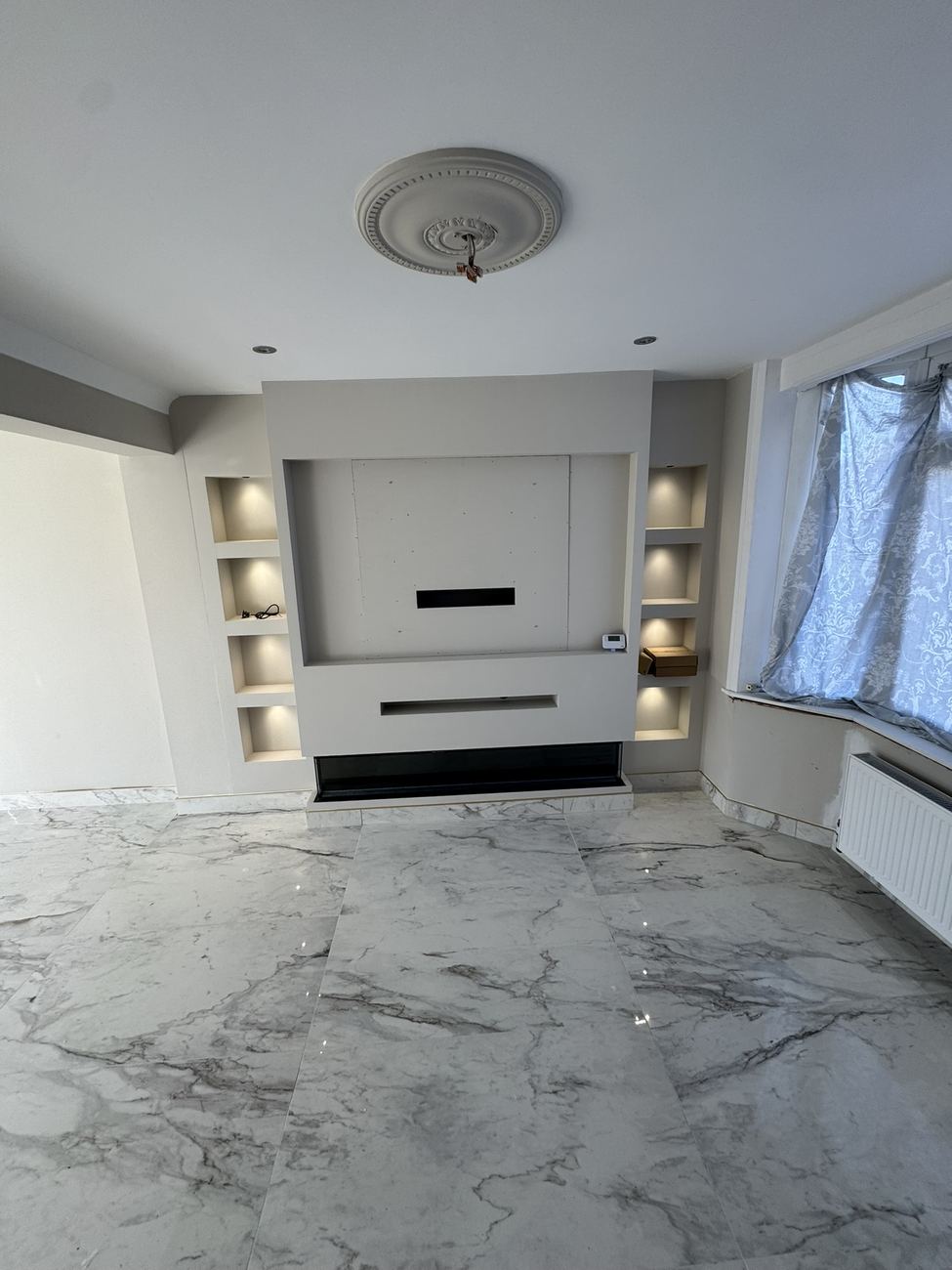 Media wall with lit alcove shelving