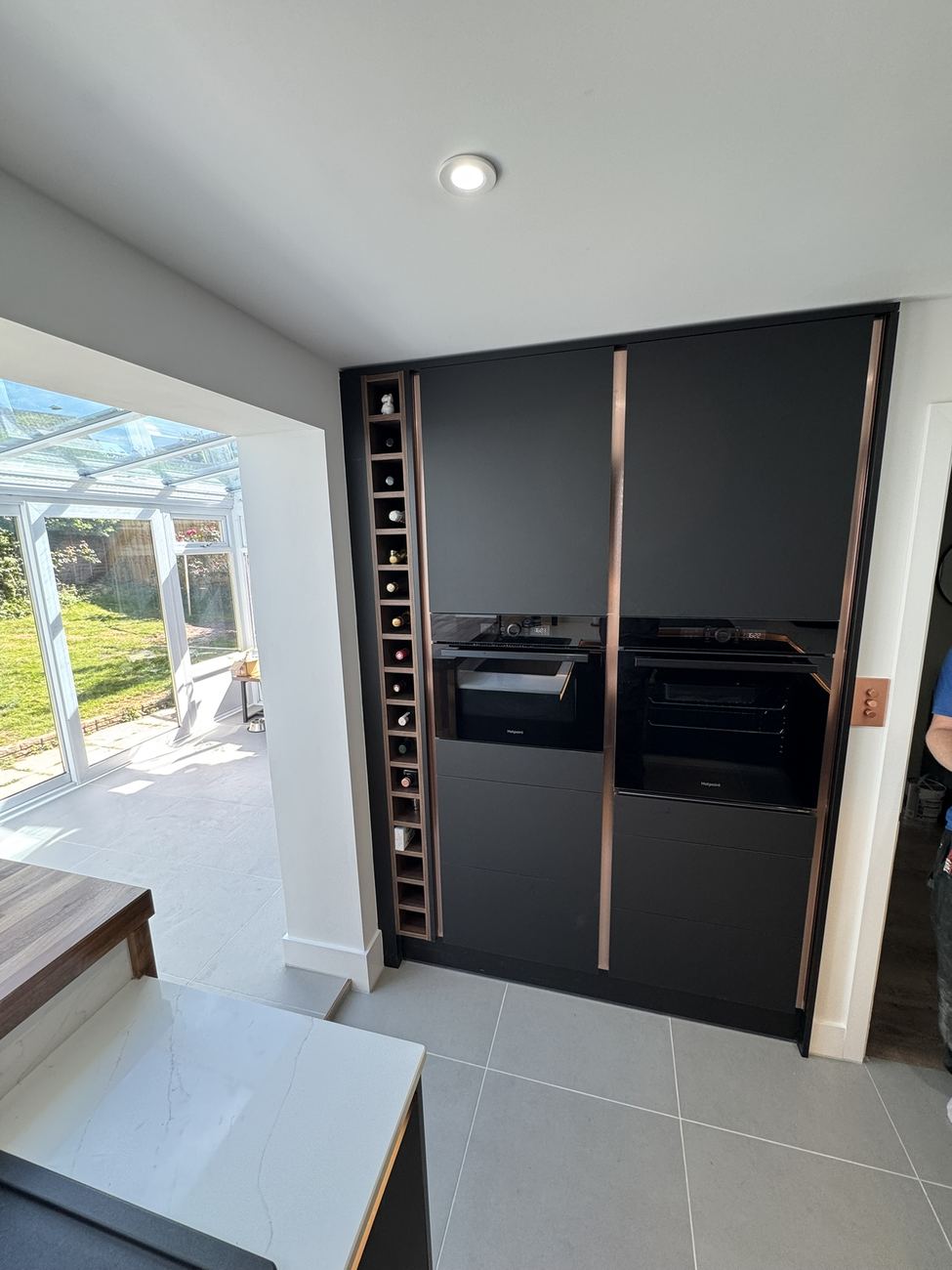 Tall black kitchen units with wine rack
