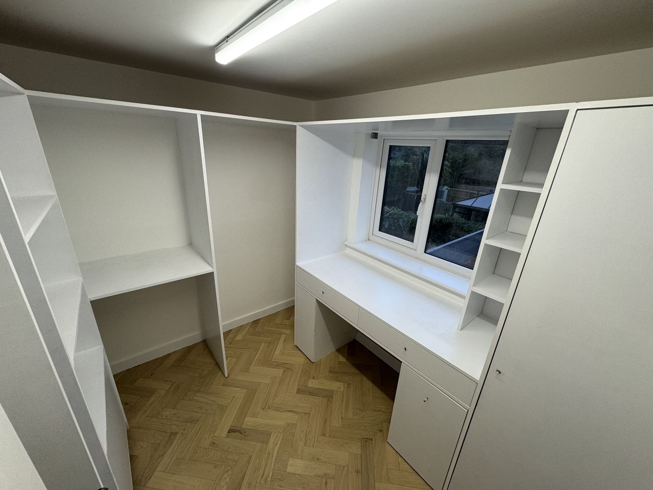 Built-in desk and shelving around a window