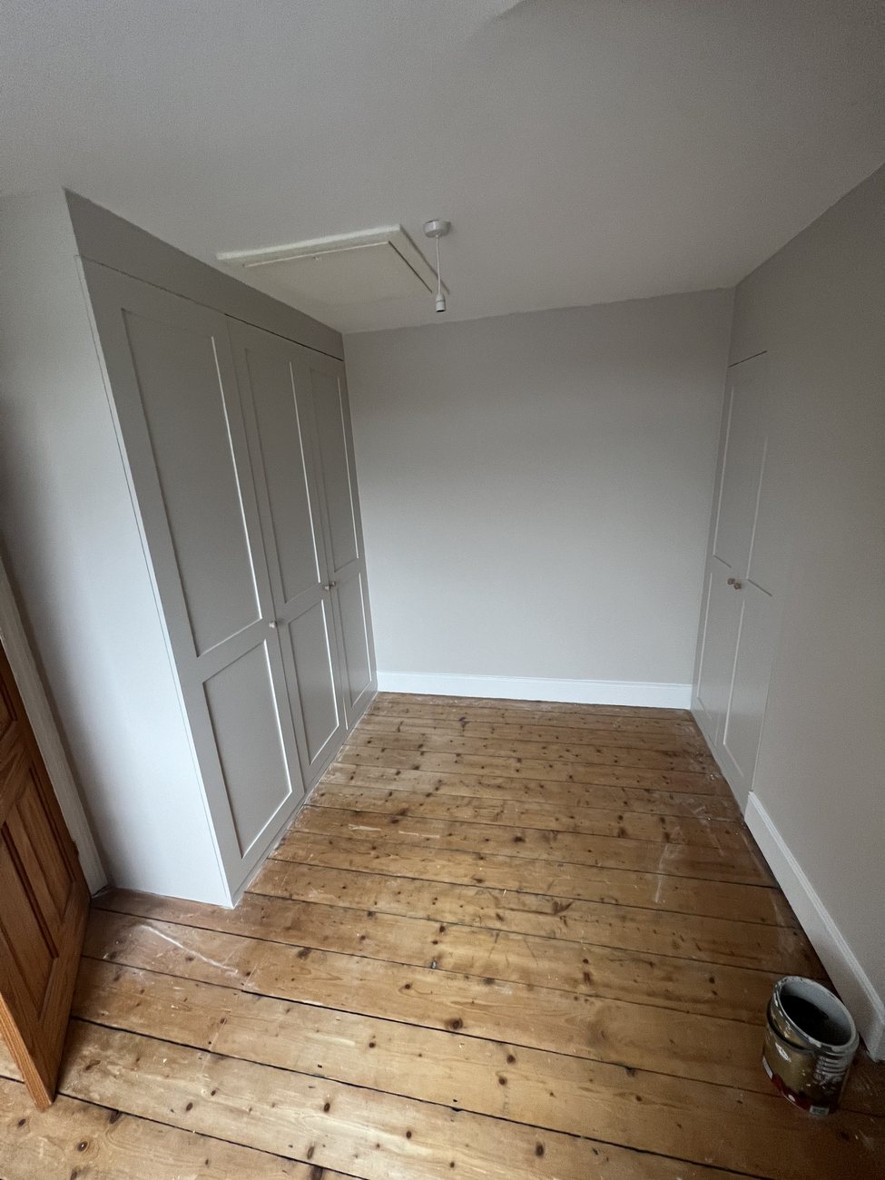 Built-in shaker-style wardrobe in a loft bedroom